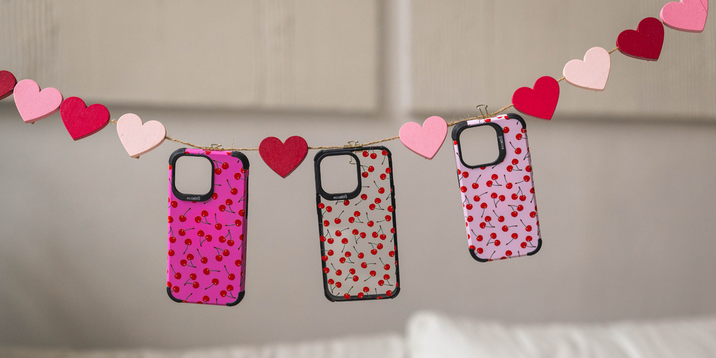Streamer of Pink ands Red Hearts with 3 EcoBlvd Compostable Phone Cases With Cherry On Top Designs in Pink, Black and Pastel Lilac