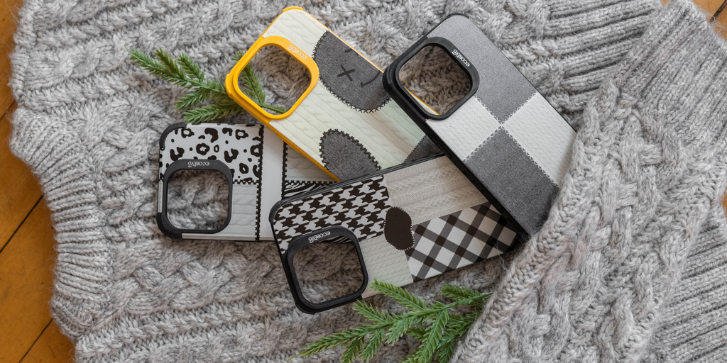 Eco-Friendly Phone Cases on top of a gray sweater with green leaves.