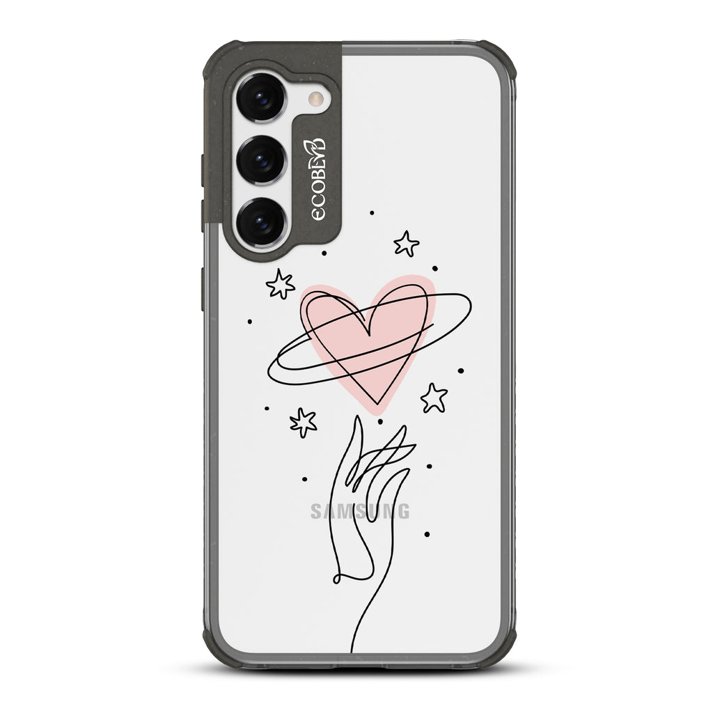 Be Still My Heart - Black Eco-Friendly Galaxy S23 Case with Hand Reaching For Pink Heart With Stars On A Clear Back