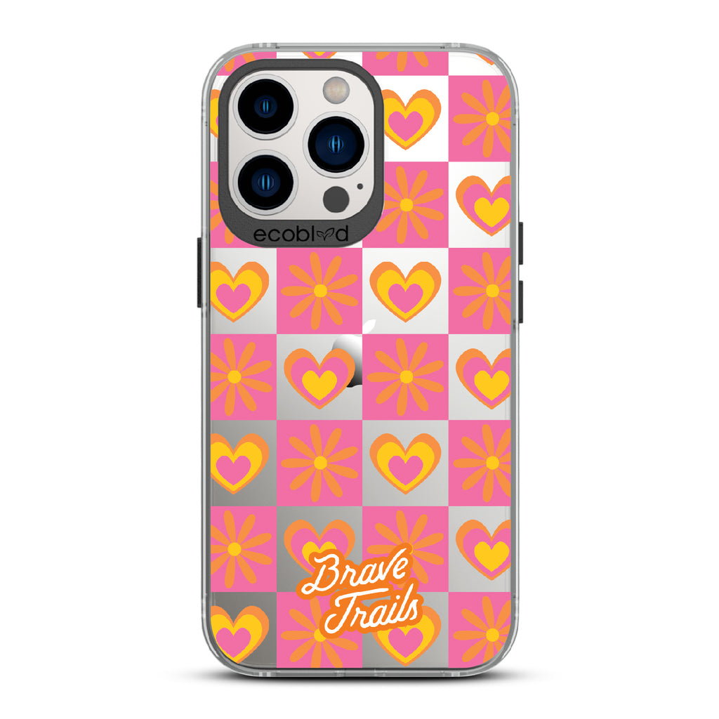 Free Spirit X Brave Trails - Black Eco-Friendly iPhone 12/13 Pro Max Case with Pink Checkered Hearts & Flowers On Clear Back
