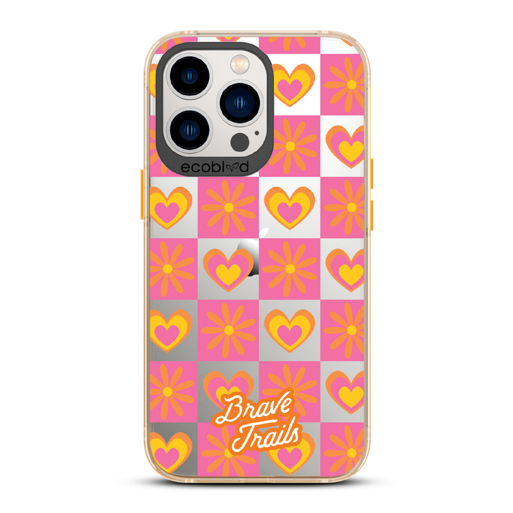 Free Spirit X Brave Trails - Yellow Eco-Friendly iPhone 12/13 Pro Max Case with Pink Checkered Hearts & Flowers On Clear Back