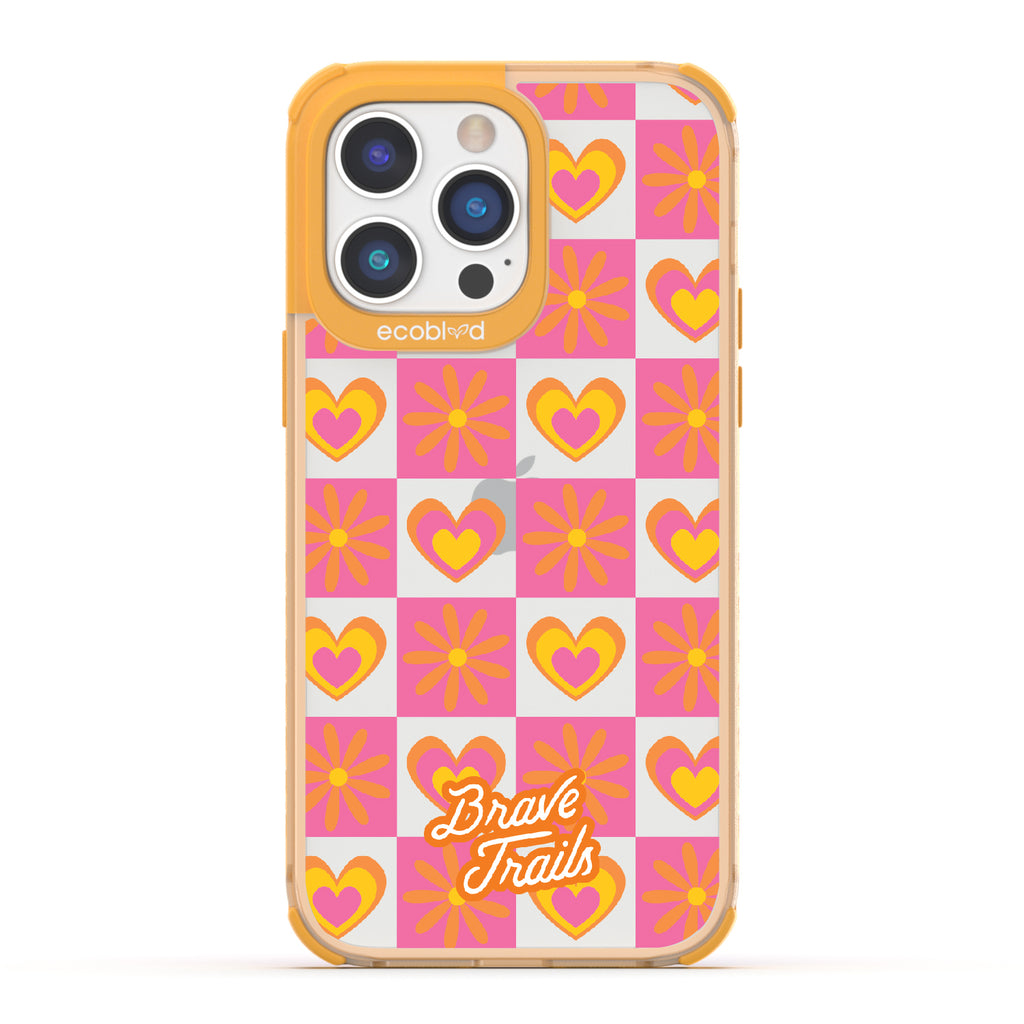 Free Spirit X Brave Trails - Yellow Eco-Friendly iPhone 14 Pro Case with Pink Checkered Hearts & Flowers On Clear Back