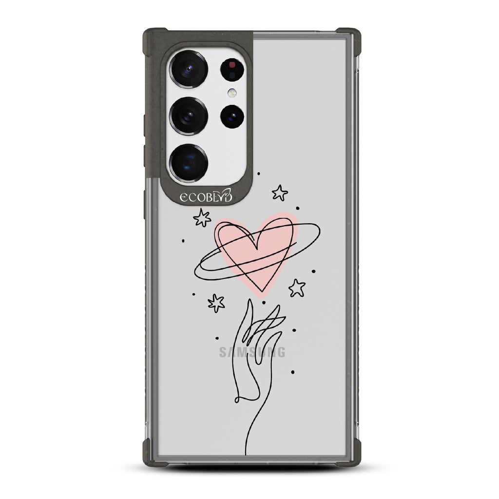 Be Still My Heart - Black Eco-Friendly Galaxy S23 Ultra Case with Hand Reaching For Pink Heart On A Clear Back