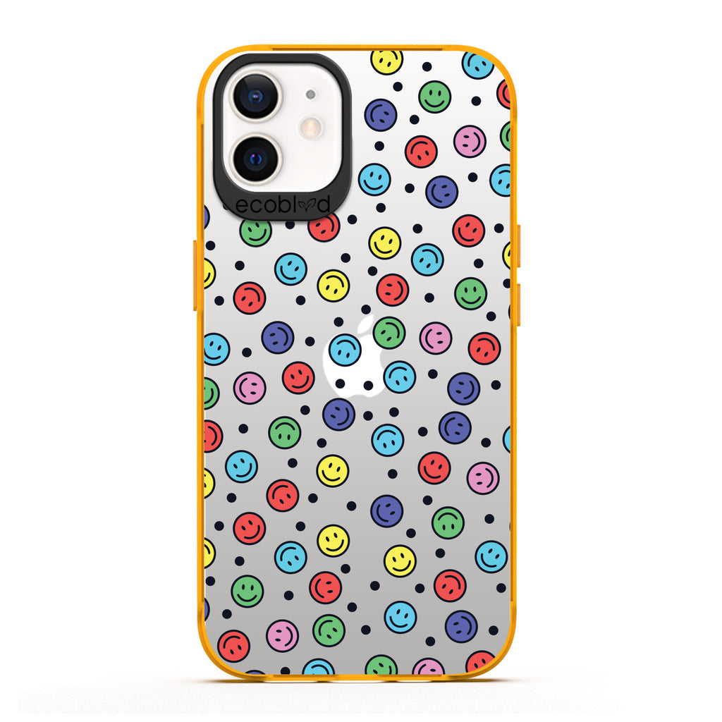 Laguna Collection - Yellow Eco-Friendly iPhone 12 / 12 Pro Case With Multicolored Smiley Faces & Black Dots On A Clear Back