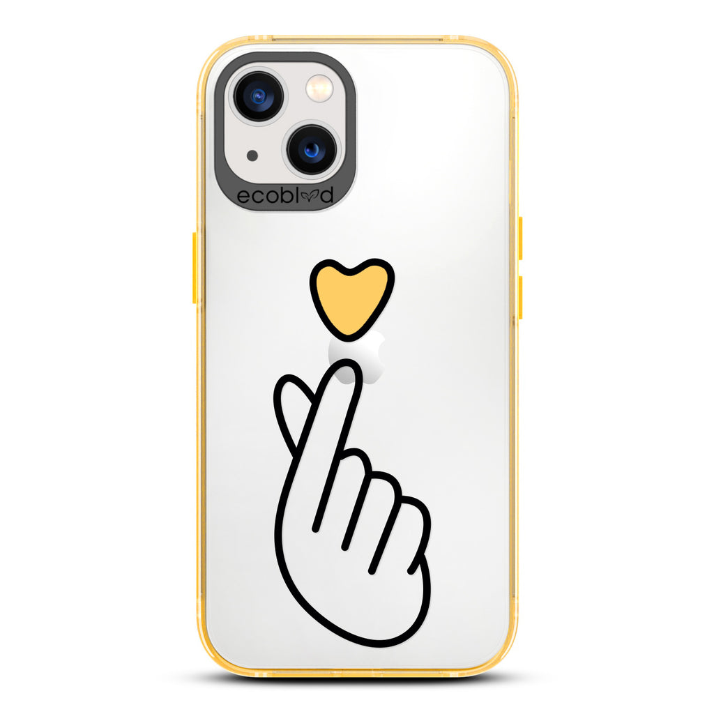Love Collection - Yellow iPhone 13 Case - Pink Heart Above Hand With Index Finger & Thumb Crossed On A Clear Back