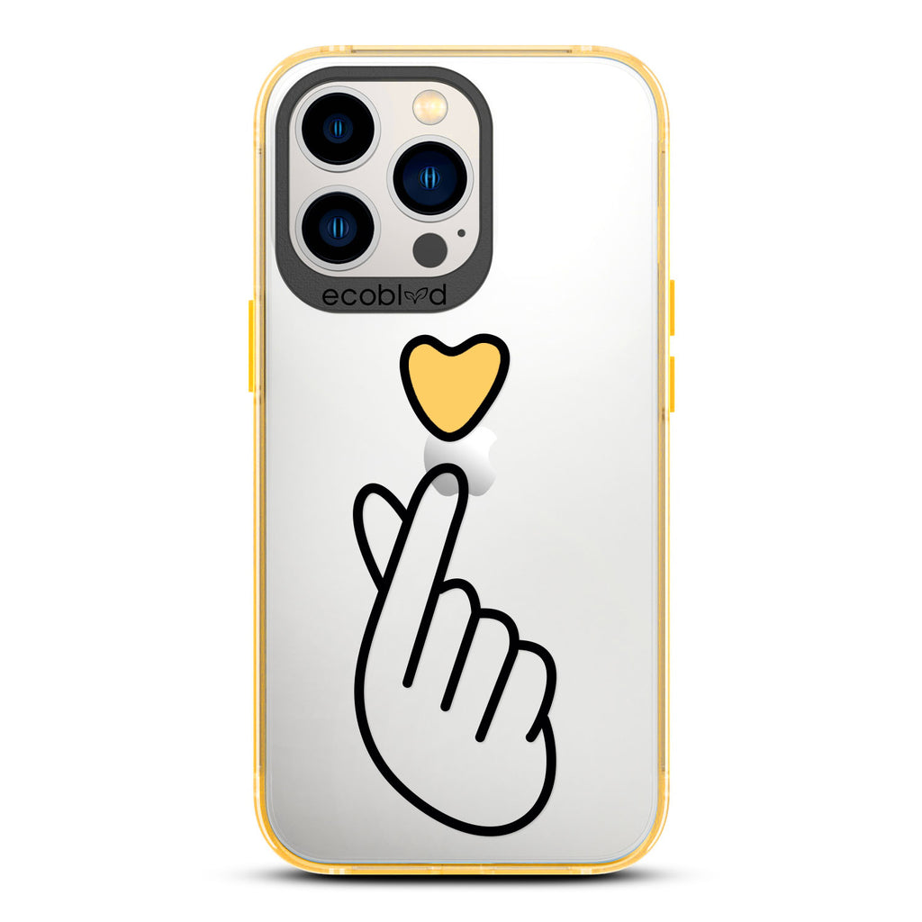 Love Collection - Yellow iPhone 13 Pro Case - Yellow Heart Above Hand With Index Finger & Thumb Crossed On A Clear Back